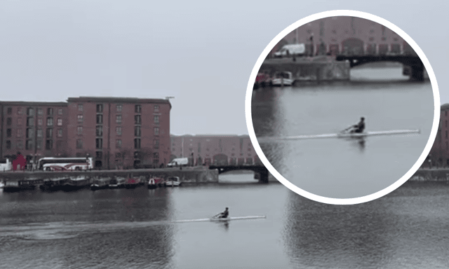 A man casually rowing on the Albert Dock as snow hits Liverpool. Image Emma Dukes