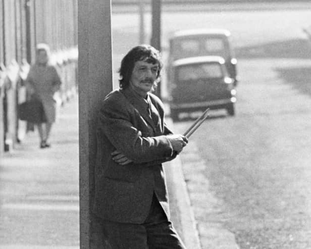 Tommy Moore, an early drummer for The Beatles, in a street near the River Mersey