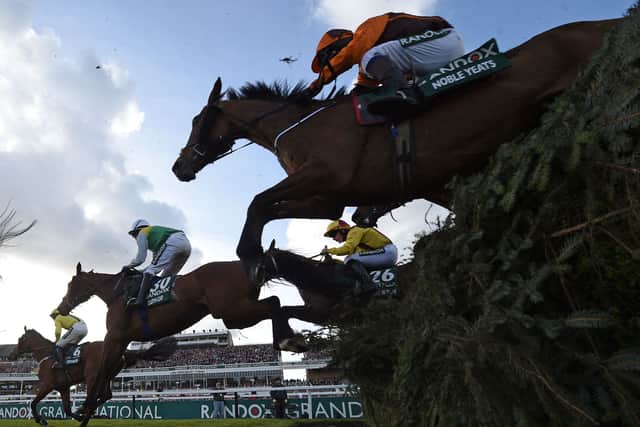 Eventual winner Noble Yeats ridden by jockey Sam Waley-Cohen take the water-jump during the Grand National Steeple Chase in April 2022