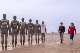 Antony Gormley’s sculptures gain six new neighbours as North West Cancer Research launches its Cancer Has No Place In Our Home campaign on Crosby Beach.  Image: Anthony Devlin