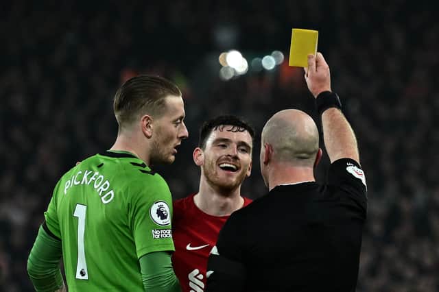 Andy Robertson of Liverpool and Jordan Pickford of Everton receive a yellow card
