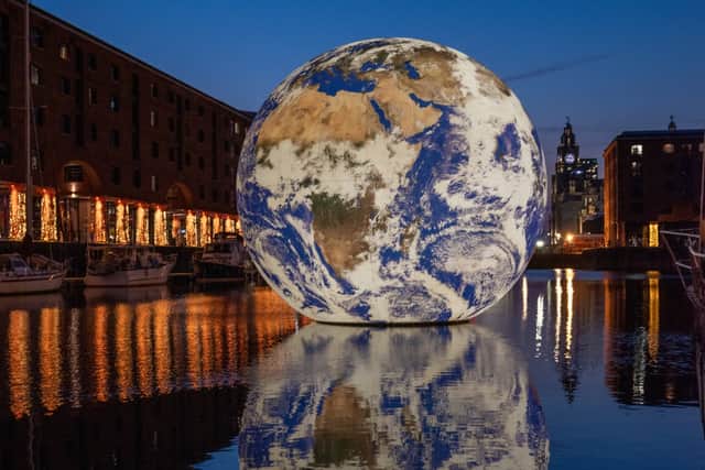Luke Jerram’s Floating Earth on the Albert Dock. Image: Mark McNulty/Think Publicity