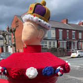 A postbox in New Brighton is topped with a knitted King Charles III. Image: Emily Bonner