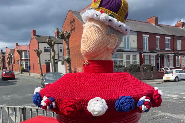 A postbox in New Brighton is topped with a knitted King Charles III. Image: Emily Bonner