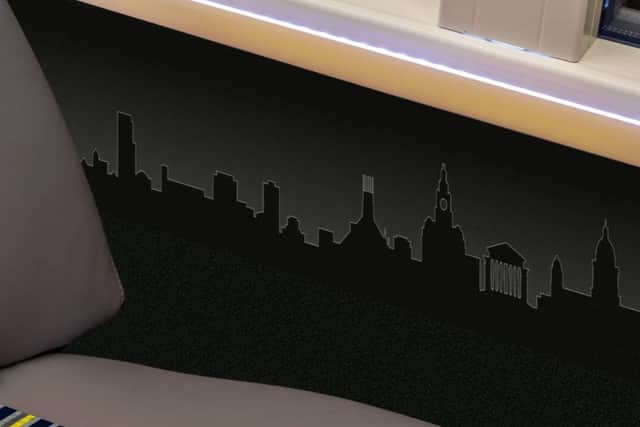 The interior of the bus is decorated with a skyline frieze featuring some of the most iconic landmarks in the Liverpool City Region, including the Liver Building, the Dream in St Helens and Anthony Gormley’s Another Place in Sefton. Image: LCR