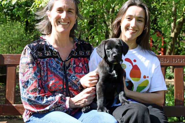 Foster carers Emma (left) and Nisha are pictured with Cocker Spaniel Cross puppy Albert who is now in his forever home.