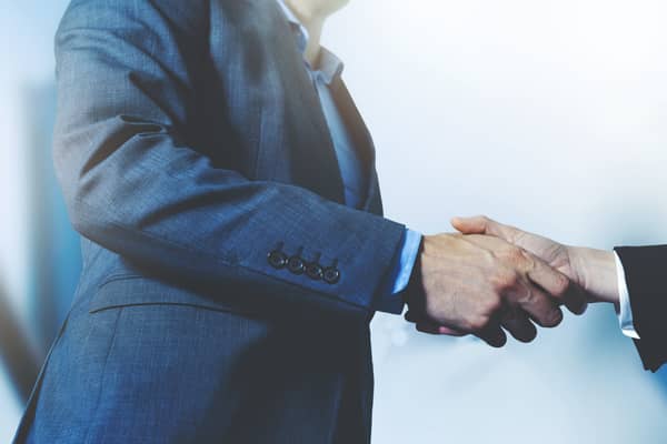 A business man and woman shake hands on a deal. Image: ronstik - stock.adobe.com