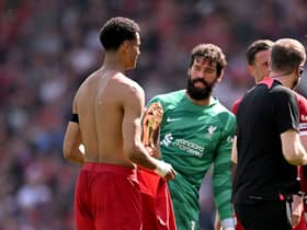 Alisson demonstrates to the referee how Liverpool teammate Cody Gakpo was fouled by Tyrone Mings
