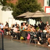 People enjoy a drink in the late summer sunshine in Liverpool city centre.