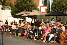 People enjoy a drink in the late summer sunshine in Liverpool city centre. Image: AFP via Getty Images