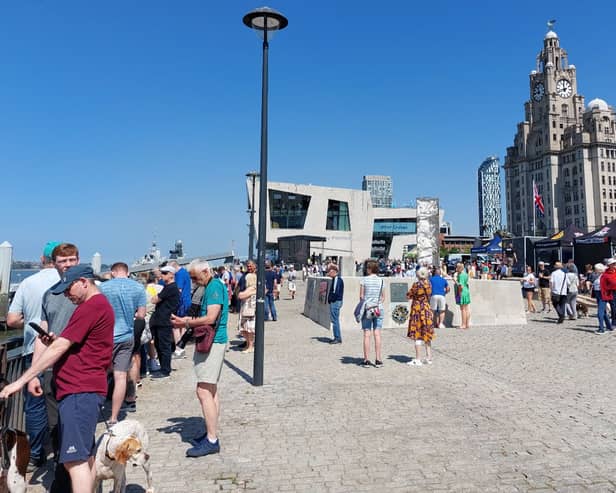 People enjoy the sunshine on Liverpool’s Pier Head.