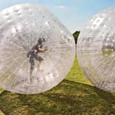 Children play in inflatable zorbs. Image: travelview - stock.adobe.com