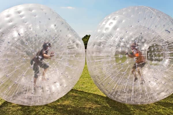 Children play in inflatable zorbs. Image: travelview - stock.adobe.com