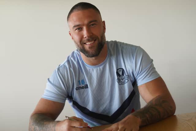 Curtis Sironen signs his new St Helens contract. Image: St Helens RFC