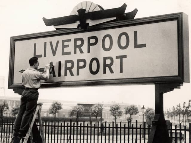 The original airport opened in 1933. Final touches to the sign.