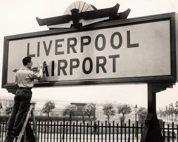 The original airport opened in 1933. Final touches to the sign.