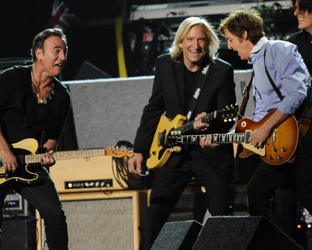 Sir Paul McCartney performs with Bruce Springsteen at the end of the 54th Grammy Awards (ROBYN BECK/AFP via Getty Images)