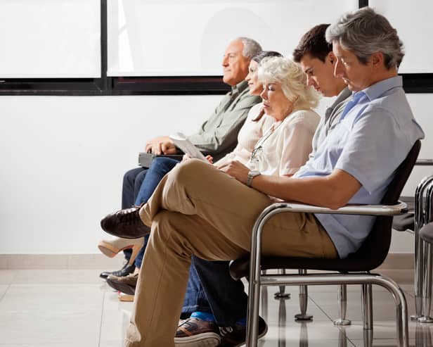 Row of people sitting side by side in doctor’s waiting room. Image: Tyler Olson - stock.adobe.com