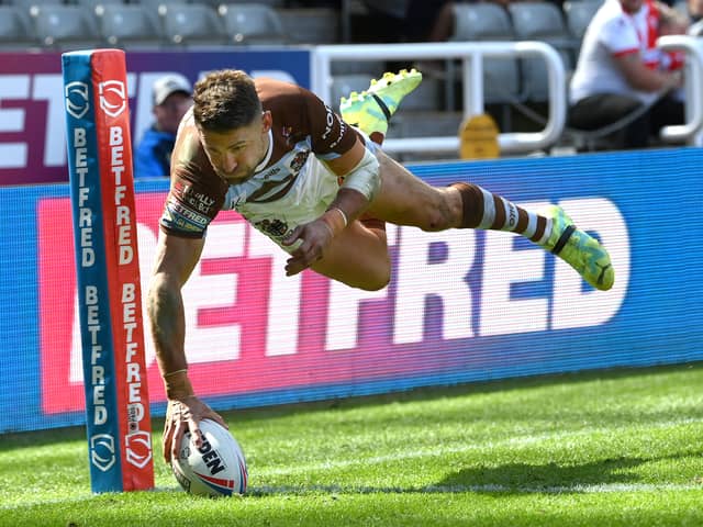 St Helens player Tommy Makinson dives in the corner for a try. Image: Stu Forster/Getty Images