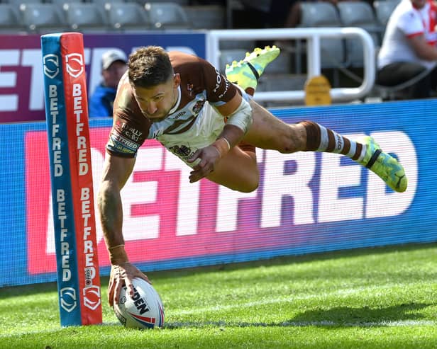 St Helens player Tommy Makinson dives in the corner for a try. Image: Stu Forster/Getty Images