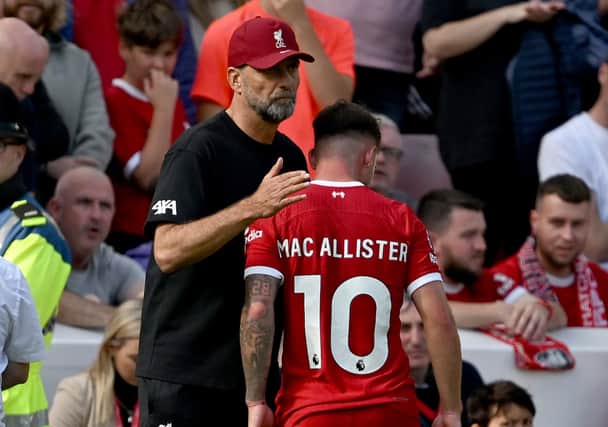 Alexis Mac Allister of Liverpool with Jurgen Klopp manager of Liverpool after being shown a red card during the Premier League match between Liverpool FC and AFC Bournemouth at Anfield on August 19, 2023 in Liverpool, England. (Photo by Andrew Powell/Liverpool FC via Getty Images)