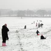 Children play on sleds on a snow covered hill in Liverpool. Image: PAUL ELLIS/AFP via Getty Images