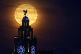 A blue supermoon rises behind the Royal Liver Building. Image: Christopher Furlong/Getty Images