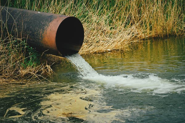 Draining sewage from pipe into river. Image: freeman83 - stock.adobe.com