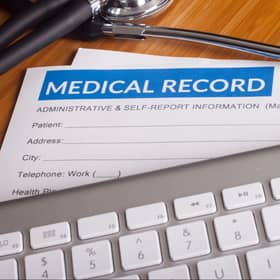 Stethoscope resting on a sheet of medical insurance records. Image: danielfela - stock.adobe.com