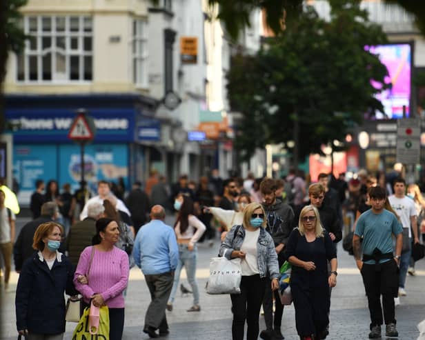 Shoppers walk through Liverpool city centre in 2020 after the government imposed fresh restrictions on the city after a rise in cases of the novel coronavirus. Photo by Oli Scarf/AFP/Getty 