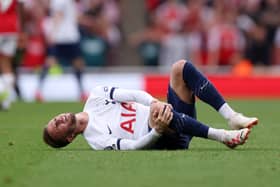James Maddison clutches his knee during Tottenham’s draw against Arsenal. Picture: Alex Pantling/Getty Images