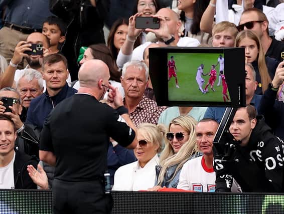 Simon Hooper watches the Video Assistant Referee before awarding a red card to Curtis Jones of Liverpool (not pictured) during the Premier League match between Tottenham Hotspur and Liverpool FC at Tottenham Hotspur Stadium on September 30, 2023 in London, England. (Photo by Ryan Pierse/Getty Images)