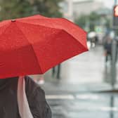 A girl under a red umbrella in the city. Image: svetlanais - stock.adobe.com