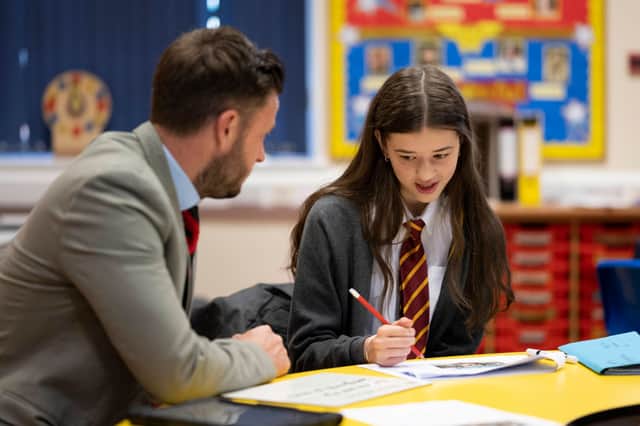 A teacher speaks to a pupil in a classroom. Photo: Matthew Horwood/Getty Images