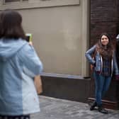 Tourists take photographs next to the statue of John Lennon of The Beatles in Matthew Street. Image: Christopher Furlong/Getty Images