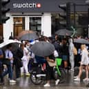 A large group of people gather outside the Swatch store as a new supply of the Omega/Swatch “Moonswatch” goes on sale. Image: Leon Neal/Getty Images