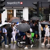 A large group of people gather outside the Swatch store as a new supply of the Omega/Swatch “Moonswatch” goes on sale. Image: Leon Neal/Getty Images