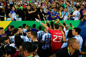 The Argentina team react as police officers clash with fans prior to a FIFA World Cup 2026 Qualifier match between Brazil and Argentina at Maracana Stadium on November 21, 2023 in Rio de Janeiro, Brazil. The match was delayed due to incidents in the stands. (Photo by Buda Mendes/Getty Images)