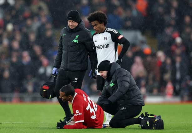 Joel Matip of Liverpool receives medical treatment during the Premier League match between Liverpool FC and Fulham FC at Anfield on December 03, 2023 in Liverpool, England. (Photo by Clive Brunskill/Getty Images)