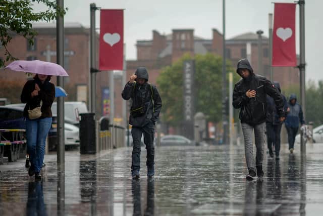 People brave the rain and wind of Storm Agnes in Liverpool. Image: Christopher Furlong/Getty Images