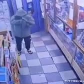 A CCTV image of the man firing a gun at Sangha newsagents on Lower House Lane, Norris Green.