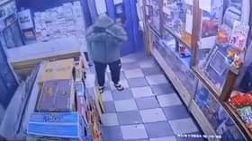 A CCTV image of the man firing a gun at Sangha newsagents on Lower House Lane, Norris Green.