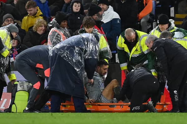 Dwight McNeil was stretchered off for Everton against Crystal Palace.   (Photo by GLYN KIRK/AFP via Getty Images)