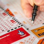 A lottery player fills out a EuroMillions ticket. Ming/Stock.adobe