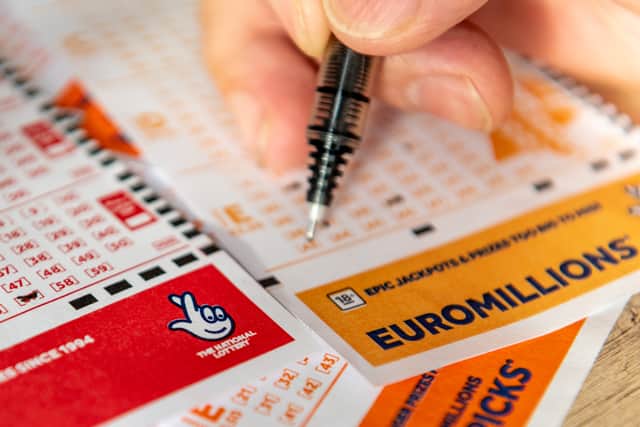 A lottery player fills out a EuroMillions ticket. Ming/Stock.adobe