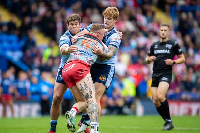 Josh Charnley of Leigh Leopards is tackled by Louie McCarthy-Scarsbrook and George Delaney of St.Helens during the Betfred Challenge Cup Semi Final match between St Helens and Leigh Leopards at The Halliwell Jones Stadium. Photo: Jess Hornby/Getty Images