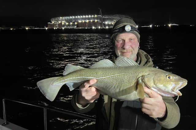 Tony Shep with a cod he caught near the Everton Stadium, a type of fish that had been caught far less in 2023 Credit: Tony Shep