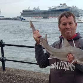 Damian Owens with a species of smooth hound shark he caught in the Mersey. Credit: Damian Owens