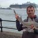 Damian Owens with a species of smooth hound shark he caught in the Mersey. Credit: Damian Owens