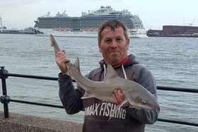 Damian Owens with a species of smooth hound shark he caught in the Mersey. Credit: Damian Owens